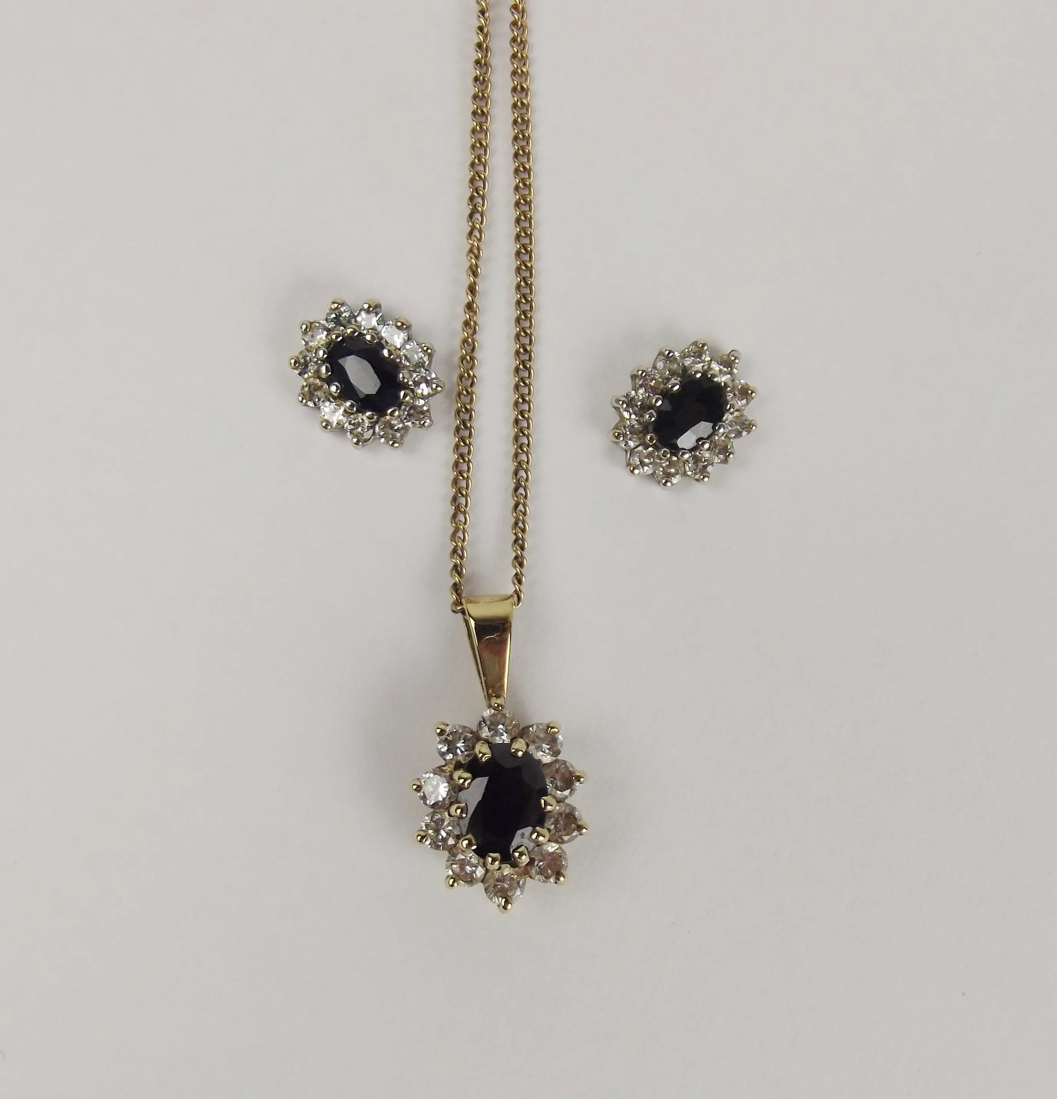 BOXED 9ct Yellow Gold Sapphire Flower Pendant surrounded by cubic zirconias 