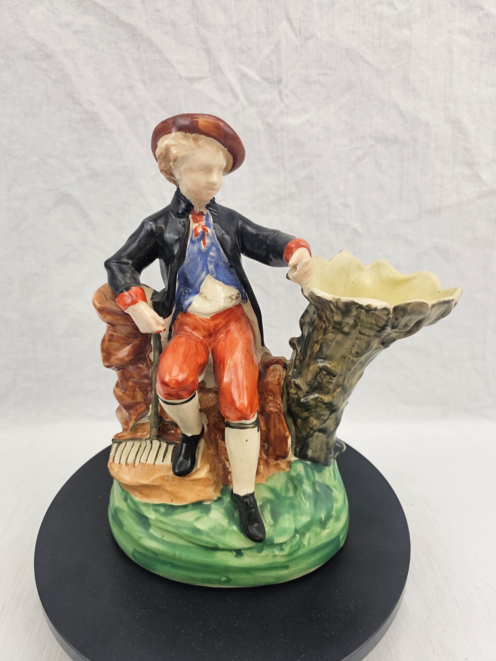 Victorian Staffordshire Earthenware Figural Spill Vase, Seated Youth in Pastoral Costume with Rake, circa 1850–1875 (1)